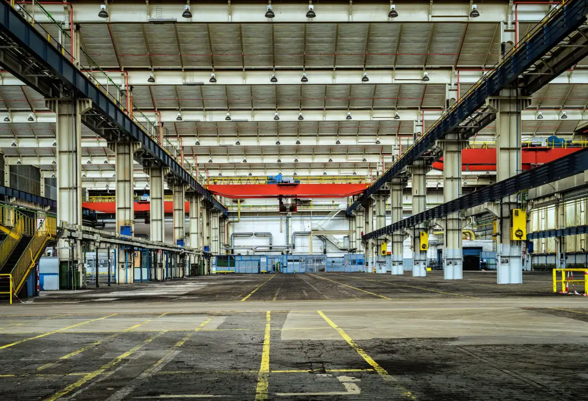 Industrial building interior with a concrete floor and painted traffic markings
