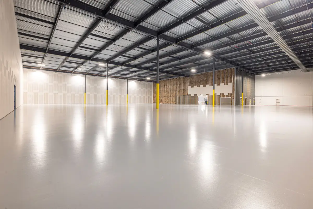 Empty warehouse with a smooth, reflective concrete floor