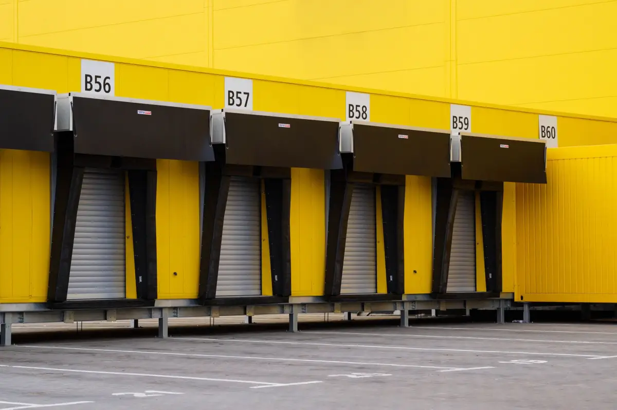 Row of loading dock doors above a concrete apron at a commercial building