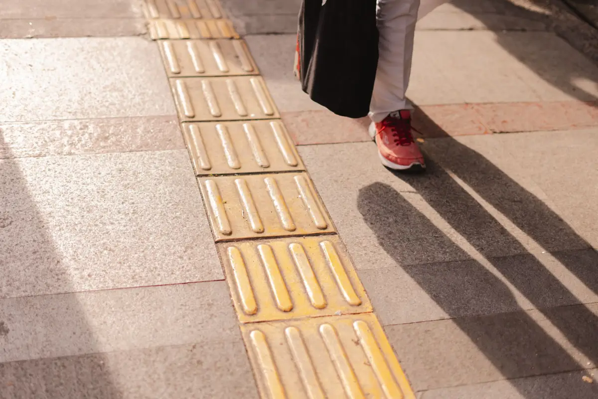 Detectable warning surface set into a concrete walkway at a crossing