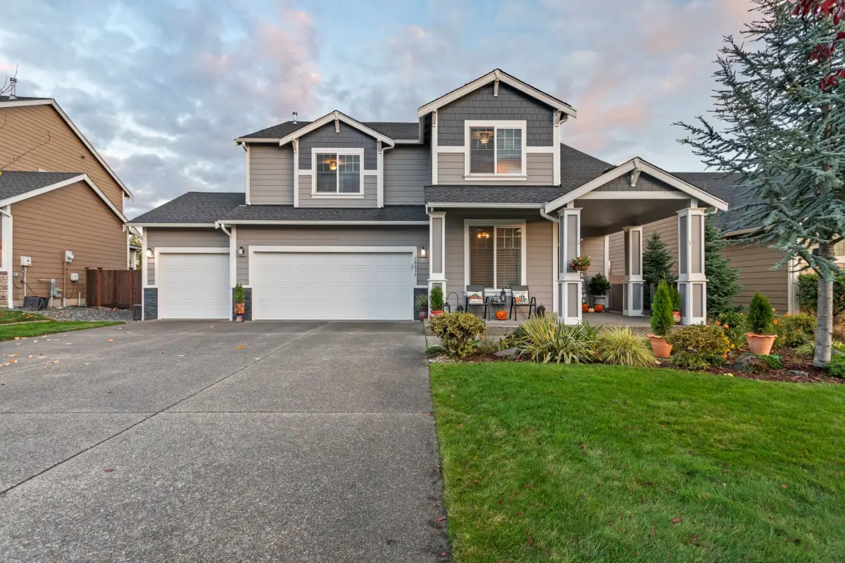 Finished concrete driveway running up to a two-car garage at a suburban home