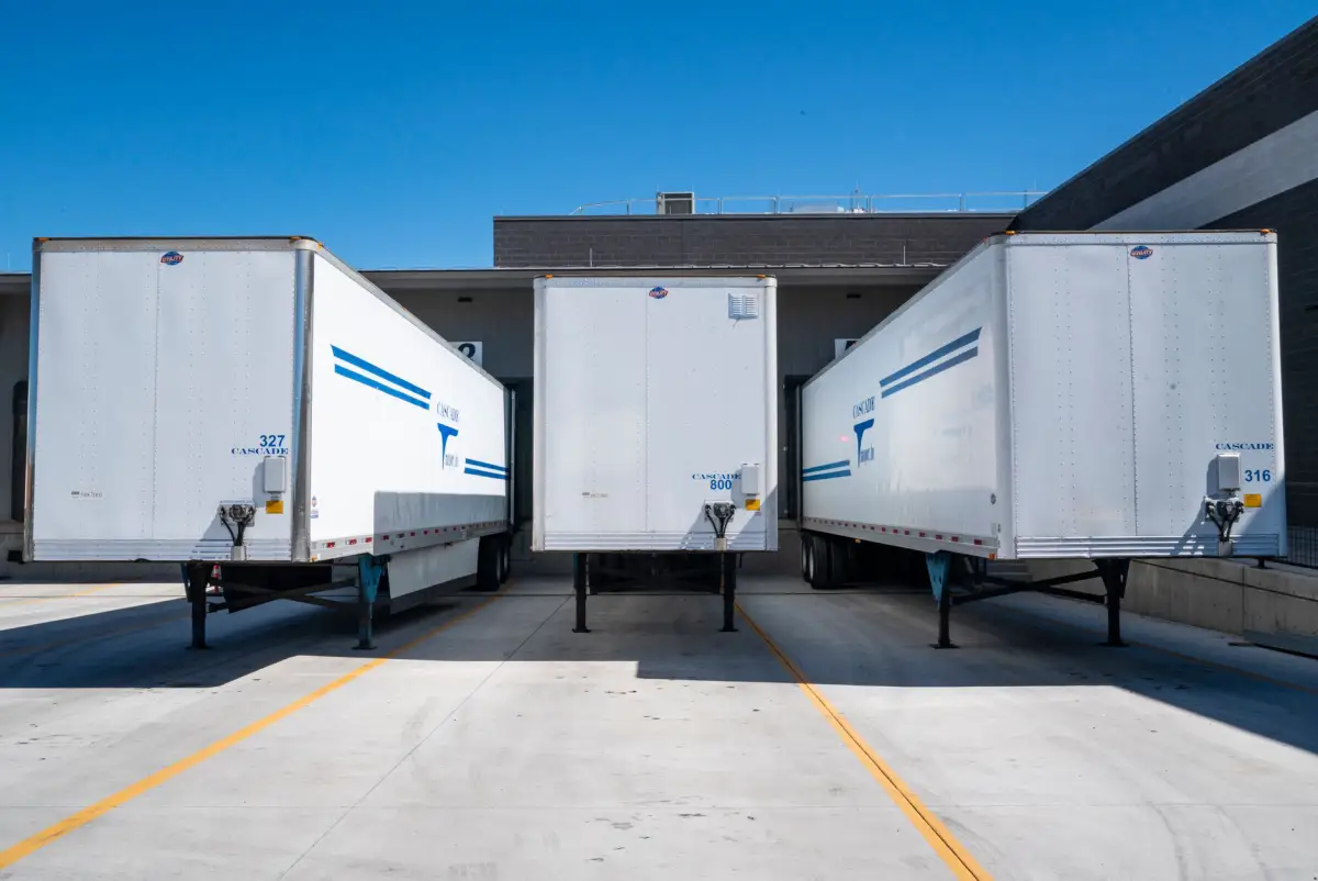 Trailers backed into a loading dock over a concrete apron