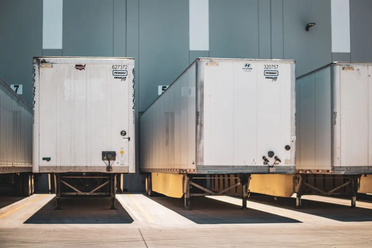 Truck trailers standing at a dock with the concrete apron in front of them