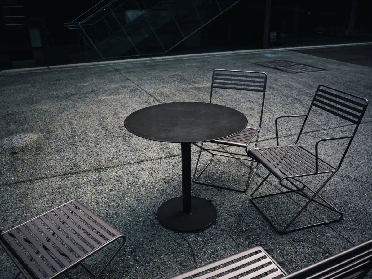 Table and chairs standing on a finished concrete patio