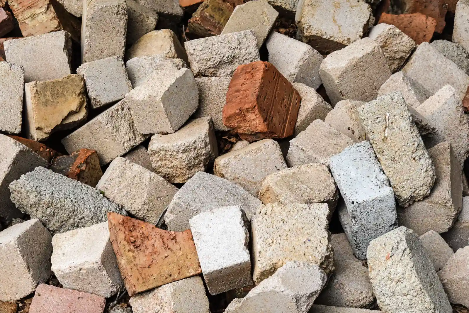 Pile of broken-out concrete chunks stacked for haul-off and recycling