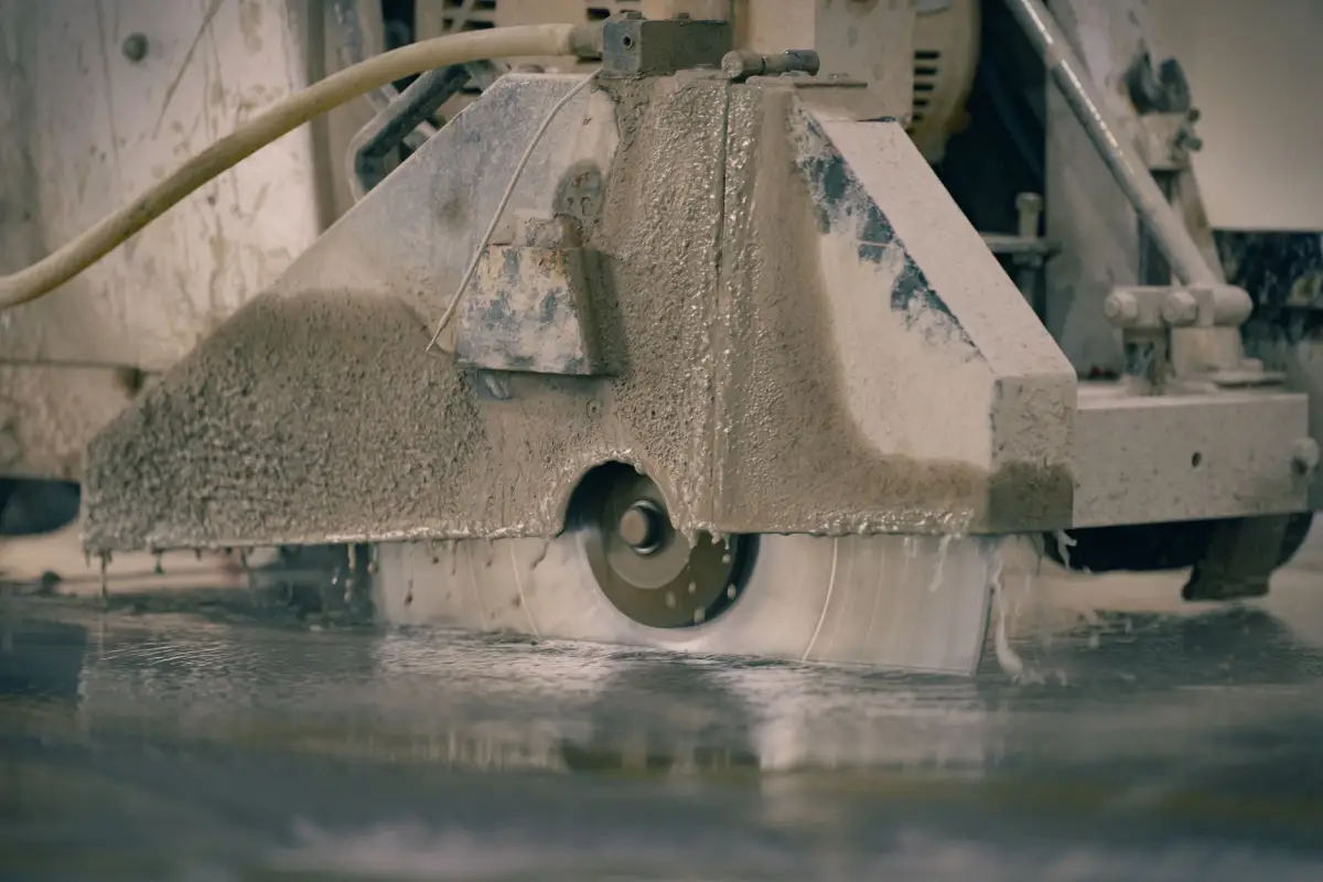 Concrete saw cutting a clean edge into a slab before removal