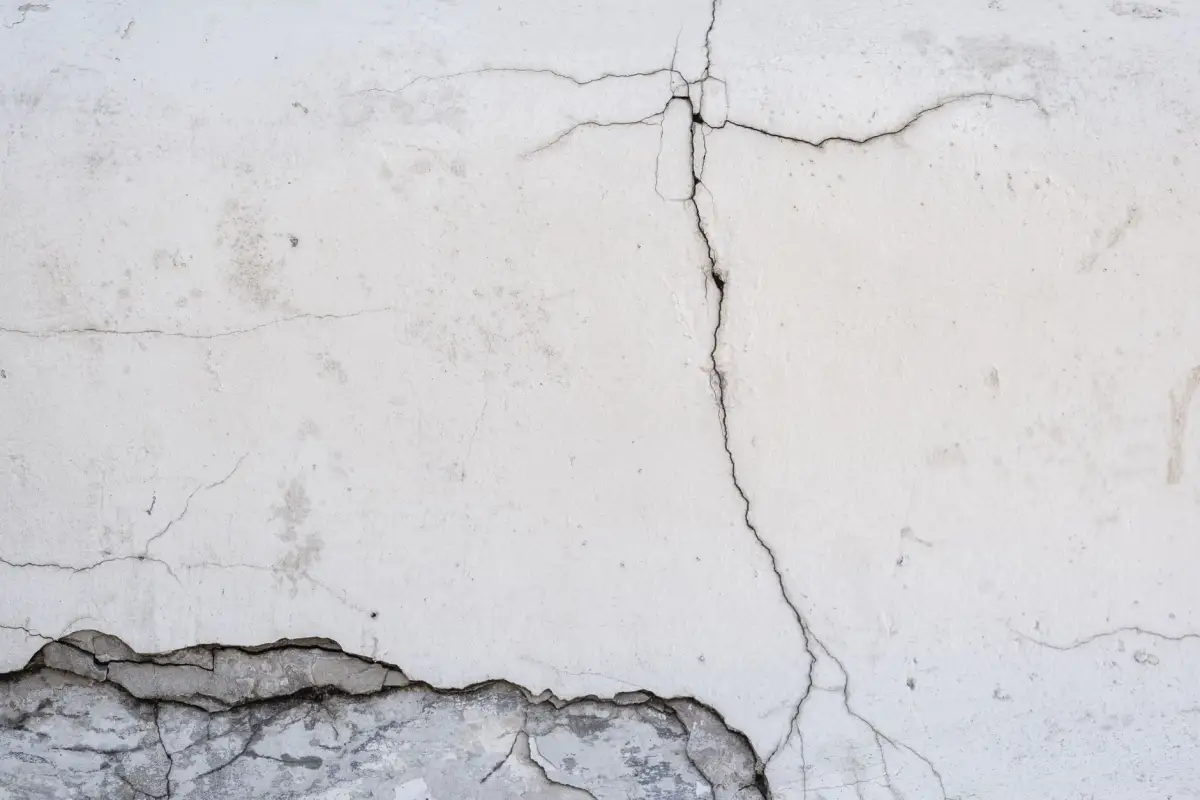 Worn concrete with cracking and a spalled edge before resurfacing