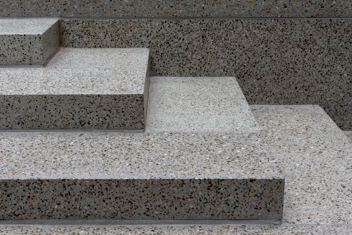 Exposed-aggregate concrete step above a contrasting smooth riser