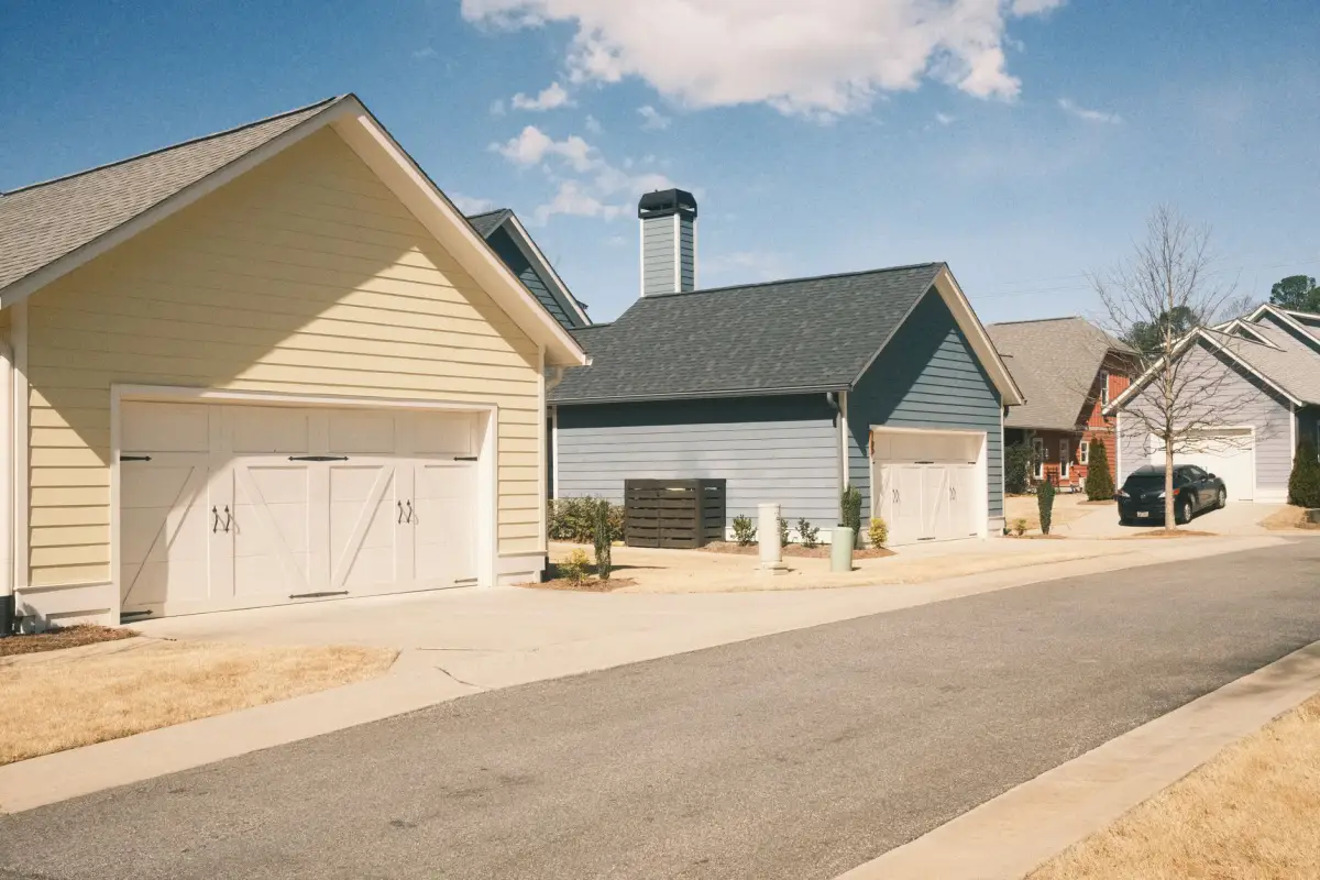 Houses with concrete driveway aprons running up to their garage doors