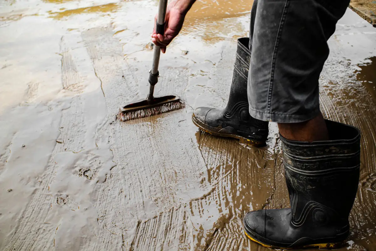 Broom drawn across wet concrete during finishing, before any pattern is applied