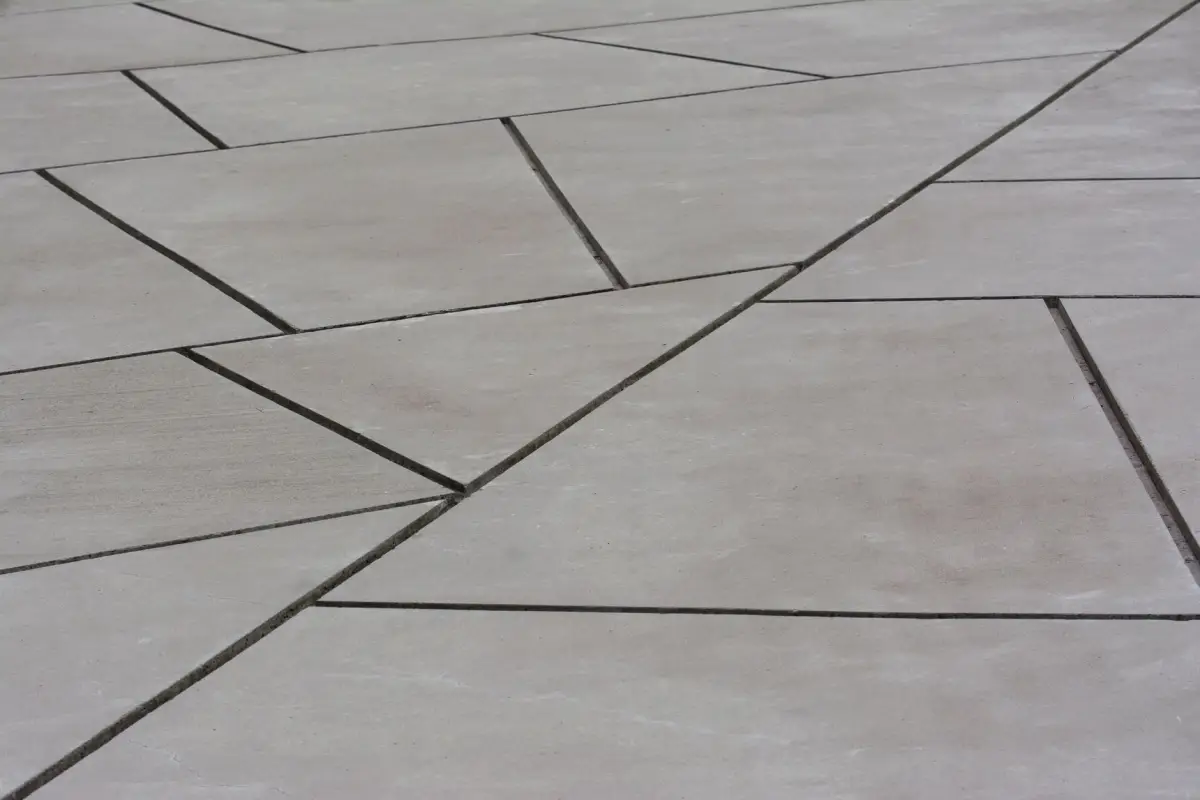 Concrete plaza divided into panels by saw-cut joints in an angular pattern